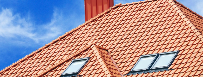 roof of the house of red tiles on background sky